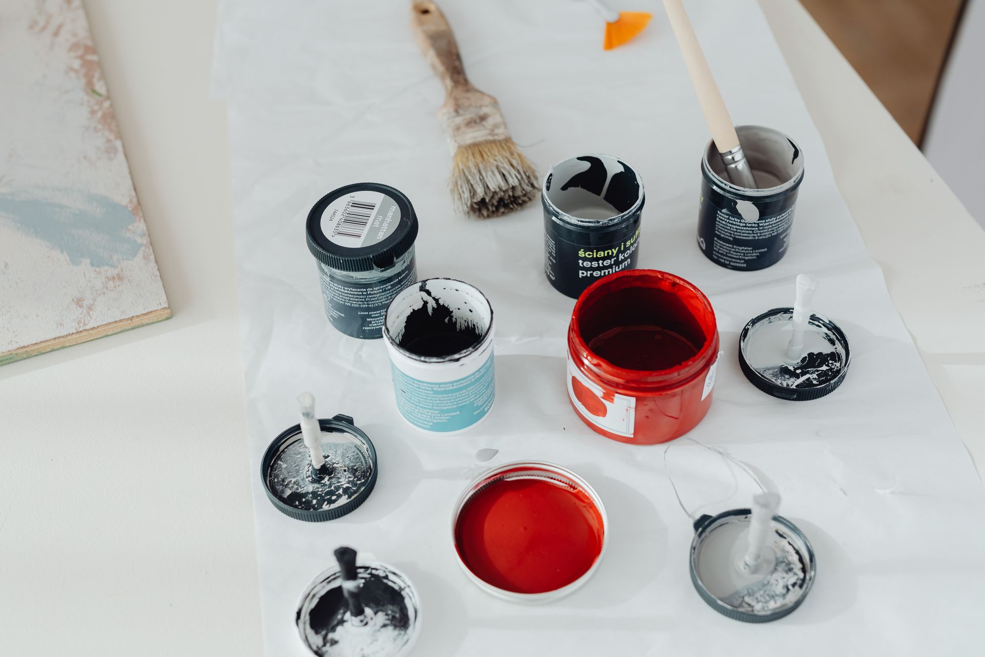 Paint materials in containers for preparation and comparison.